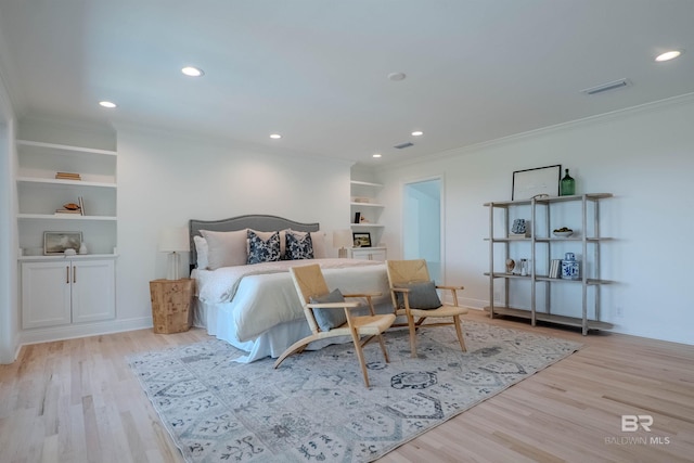 bedroom featuring light hardwood / wood-style floors and crown molding