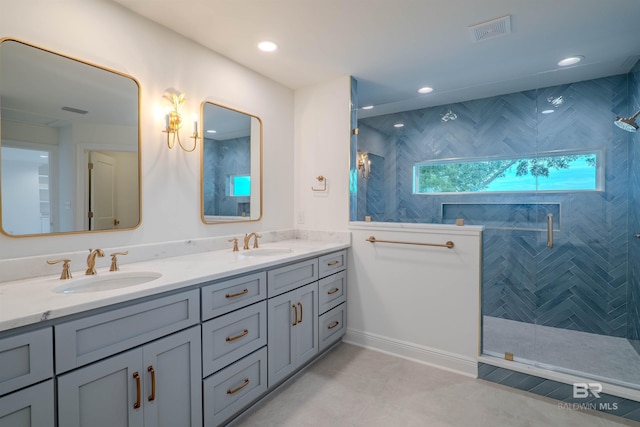 bathroom featuring a tile shower and vanity