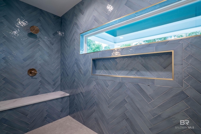 bathroom with tiled shower