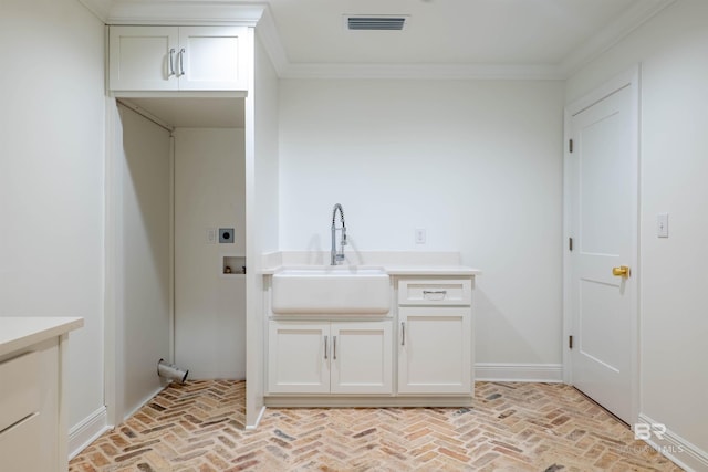 clothes washing area featuring sink, cabinets, electric dryer hookup, crown molding, and hookup for a washing machine