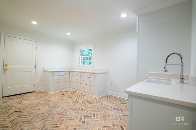 interior space with crown molding and sink