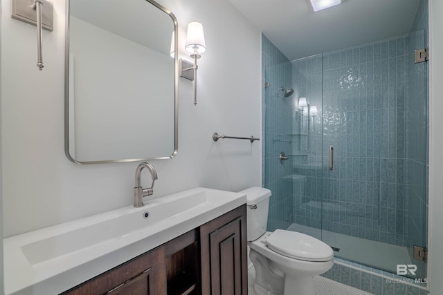 bathroom with vanity, toilet, and an enclosed shower