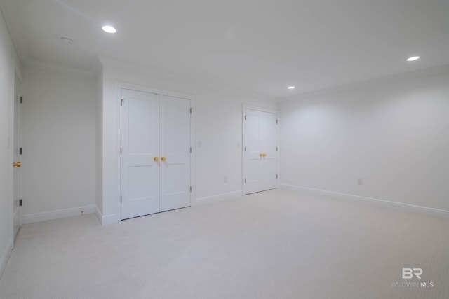 unfurnished bedroom featuring light colored carpet and ornamental molding