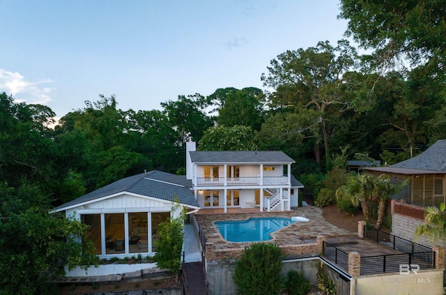 back of property featuring a balcony and a patio