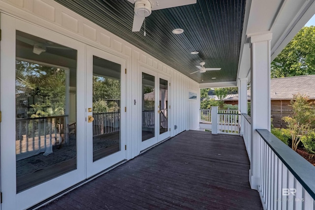 wooden deck featuring ceiling fan, french doors, and covered porch