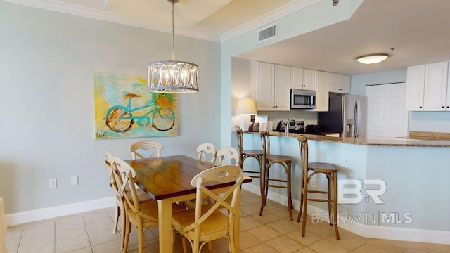 375 Beach Club Trl Unit A-1608, Gulf Shores, AL 36542 - dining room featuring crown molding, a chandelier, light tile patterned floors, and baseboards