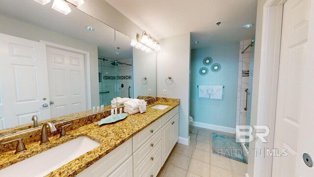 375 Beach Club Trl Unit A-1608, Gulf Shores, AL 36542 - full bathroom with a shower stall, toilet, tile patterned flooring, double vanity, and baseboards