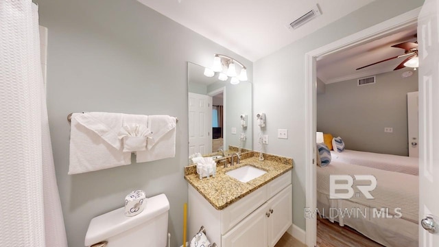 375 Beach Club Trl Unit A-1608, Gulf Shores, AL 36542 - bathroom featuring toilet, a ceiling fan, vanity, and wood finished floors