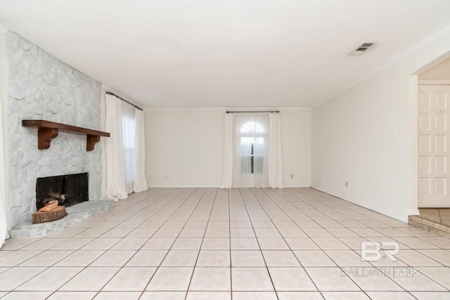 unfurnished living room featuring light tile patterned floors, a fireplace, and visible vents