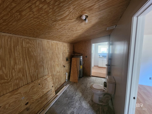 bathroom with electric water heater, toilet, wooden ceiling, and wood walls