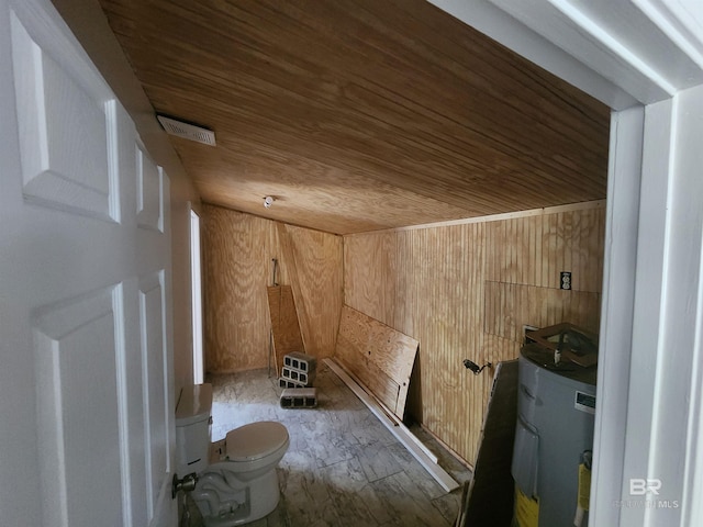 bathroom with wood walls, toilet, wooden ceiling, and water heater