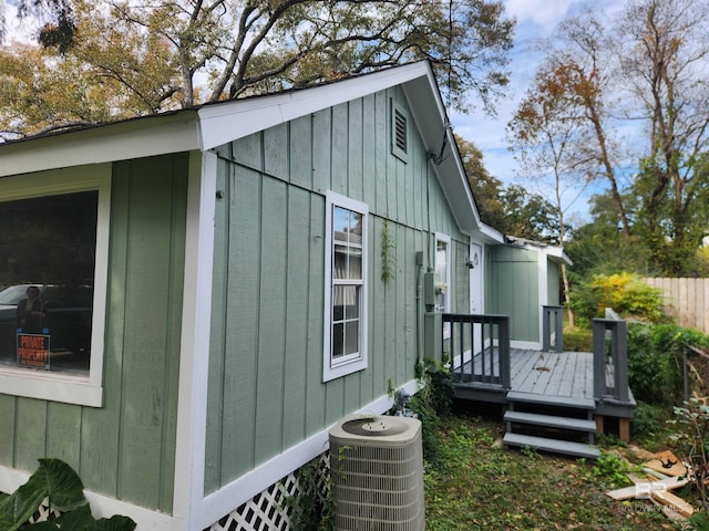 view of property exterior featuring central AC and a deck