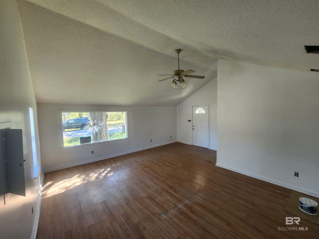 unfurnished living room with a textured ceiling, dark hardwood / wood-style floors, ceiling fan, and lofted ceiling