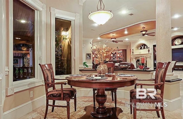 dining space with ceiling fan and ornamental molding