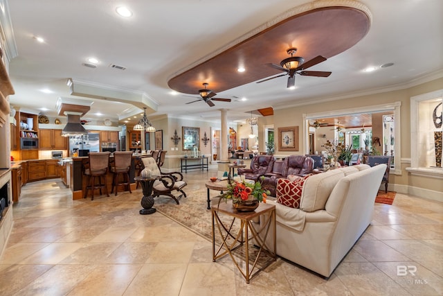 living room featuring ornamental molding, decorative columns, and ceiling fan