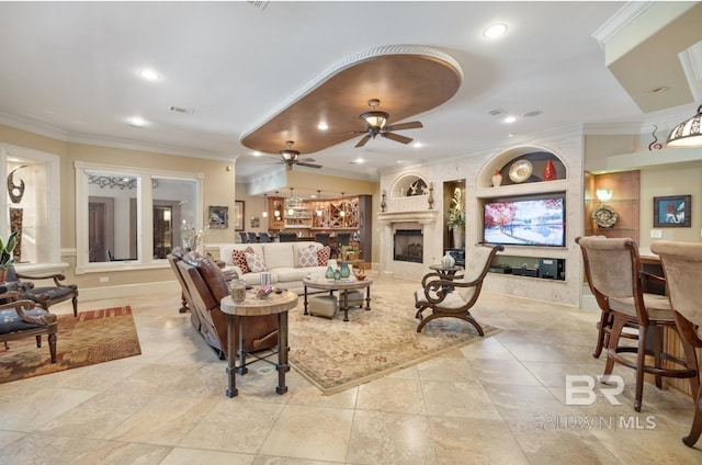 living room featuring crown molding, ceiling fan, and a fireplace