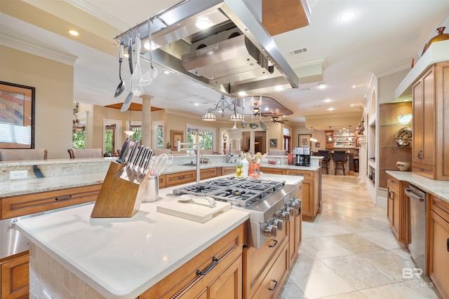 kitchen featuring pendant lighting, crown molding, a spacious island, and appliances with stainless steel finishes