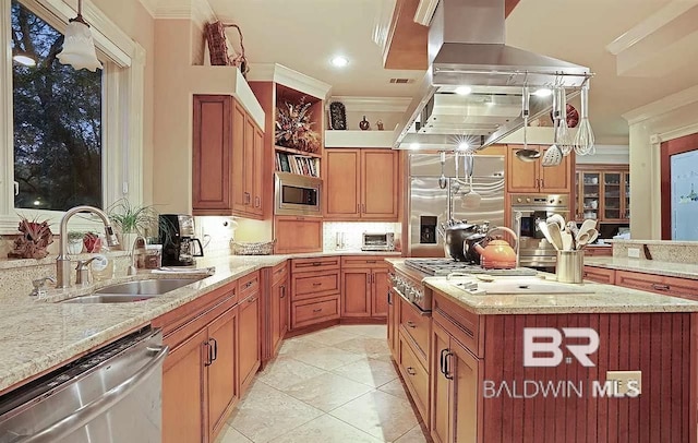 kitchen with ornamental molding, sink, a center island, and built in appliances