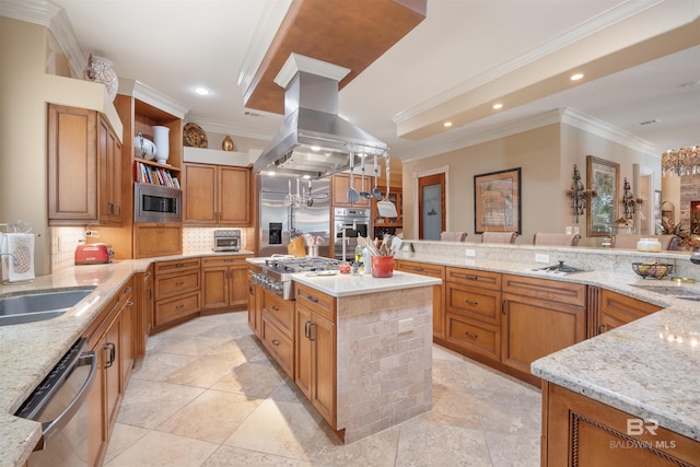 kitchen with island range hood, sink, a center island, built in appliances, and light stone counters