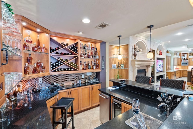 bar with tasteful backsplash, hanging light fixtures, and light tile patterned floors