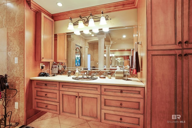 bathroom with tile patterned floors, ornate columns, crown molding, tile walls, and vanity