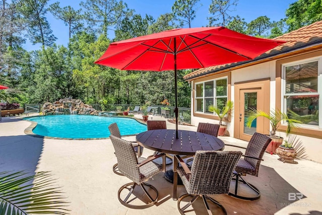 view of pool featuring pool water feature and a patio area