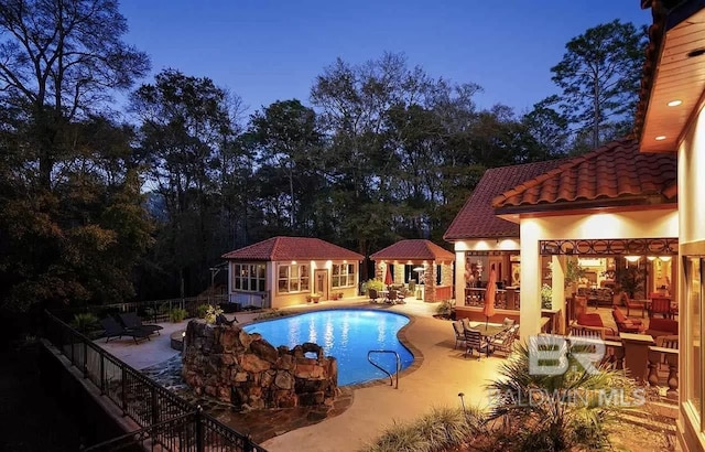 view of pool with an outbuilding and a patio area