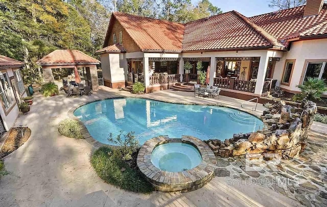 view of pool with a gazebo, an in ground hot tub, and a patio area