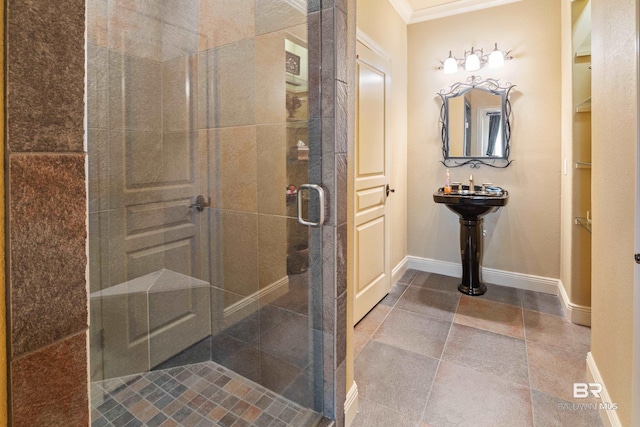 bathroom featuring crown molding and a shower with shower door