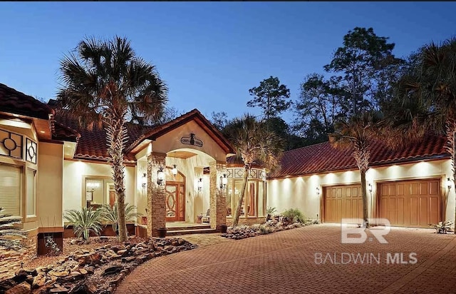 mediterranean / spanish-style house featuring a garage