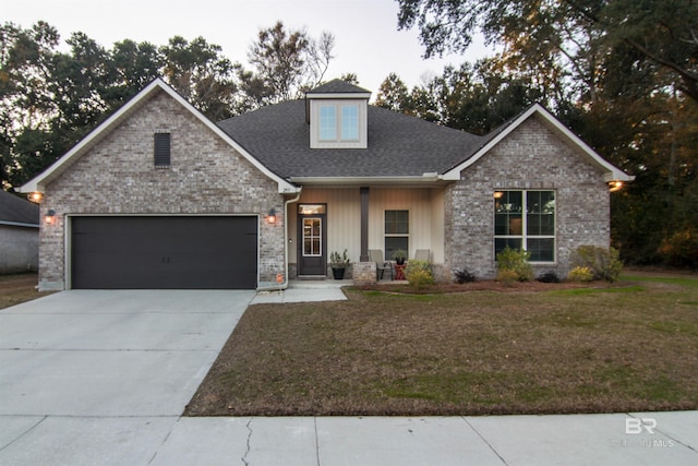 craftsman-style home featuring a garage, covered porch, and a front yard