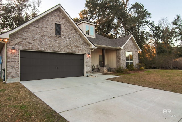 view of front of house featuring a garage and a front yard