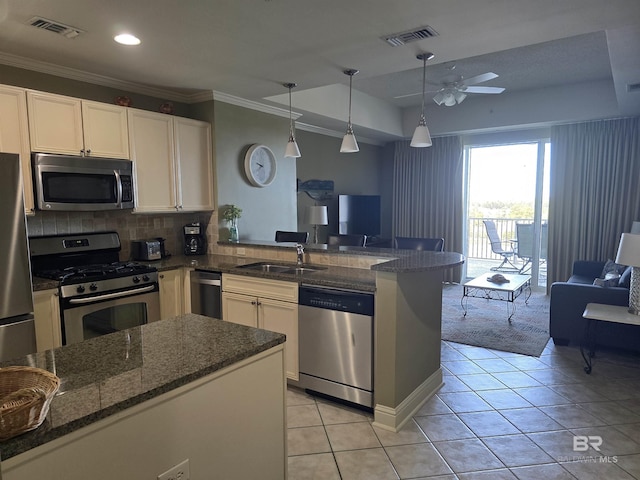 kitchen featuring pendant lighting, sink, stainless steel appliances, light tile patterned flooring, and decorative backsplash