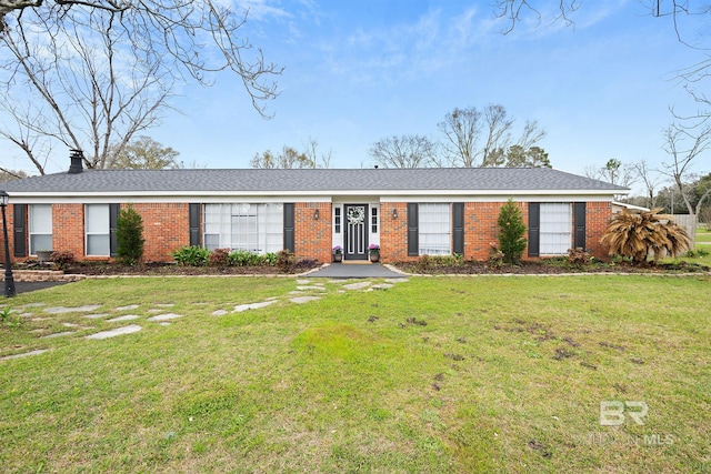 ranch-style house with a front yard, brick siding, and a chimney