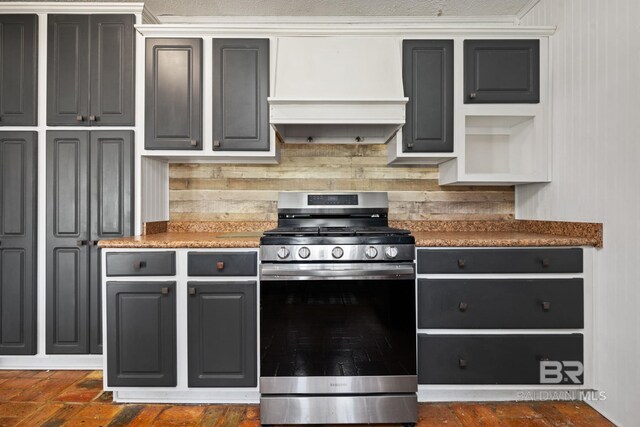 kitchen featuring premium range hood, tasteful backsplash, stainless steel range with gas cooktop, and gray cabinetry