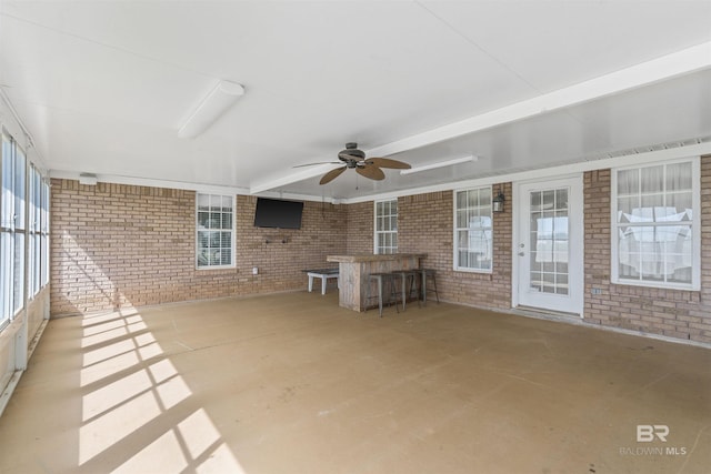 17570 Driskell Rd, Loxley, AL 36551 - unfurnished sunroom with brick wall, ceiling fan, and unfinished concrete flooring