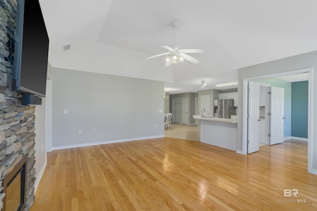 17570 Driskell Rd, Loxley, AL 36551 - unfurnished living room featuring a fireplace, a ceiling fan, and light wood-style floors