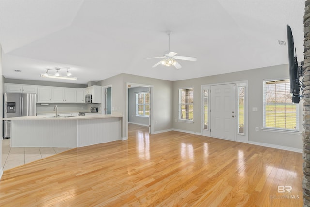 17570 Driskell Rd, Loxley, AL 36551 - unfurnished living room with a ceiling fan, lofted ceiling, and light wood-style flooring