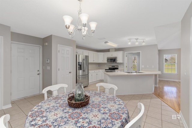 17570 Driskell Rd, Loxley, AL 36551 - dining space with light tile patterned floors and a chandelier