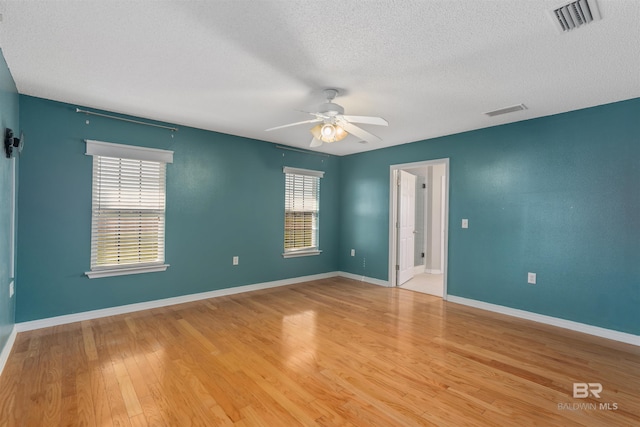 17570 Driskell Rd, Loxley, AL 36551 - empty room featuring ceiling fan, light wood finished floors, and a textured ceiling