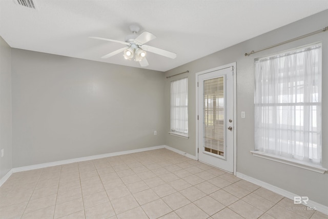 17570 Driskell Rd, Loxley, AL 36551 - empty room with ceiling fan and light tile patterned flooring