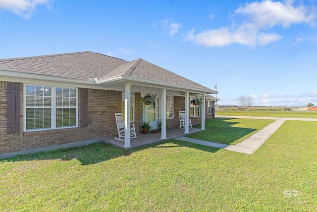 17570 Driskell Rd, Loxley, AL 36551 - view of side of home featuring brick siding, a yard, a shingled roof, and covered porch