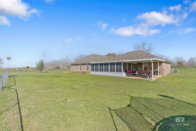 17570 Driskell Rd, Loxley, AL 36551 - back of property with a sunroom, a fenced backyard, brick siding, a patio, and an outdoor living space