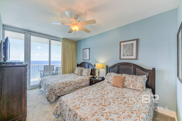 521 W Beach Blvd Unit 2102, Gulf Shores, AL 36542 - carpeted bedroom with access to exterior, a water view, and a ceiling fan