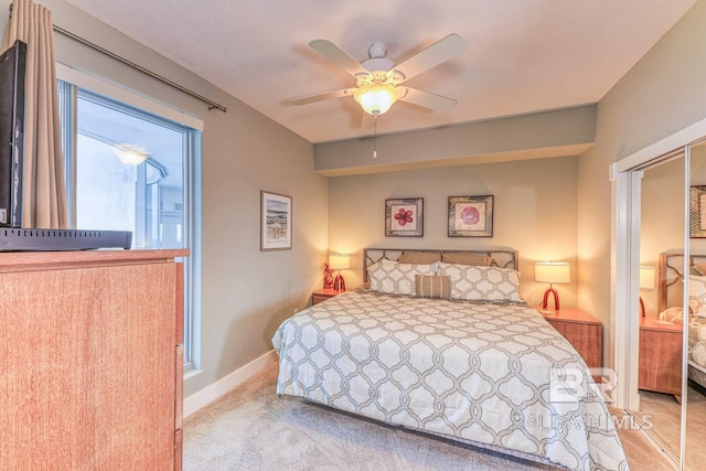 521 W Beach Blvd Unit 2102, Gulf Shores, AL 36542 - bedroom with light carpet, baseboards, and a ceiling fan