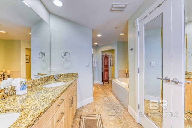 521 W Beach Blvd Unit 2102, Gulf Shores, AL 36542 - full bathroom featuring double vanity, a garden tub, recessed lighting, baseboards, and tile patterned flooring
