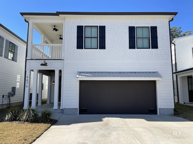 view of front of house featuring a garage and a balcony