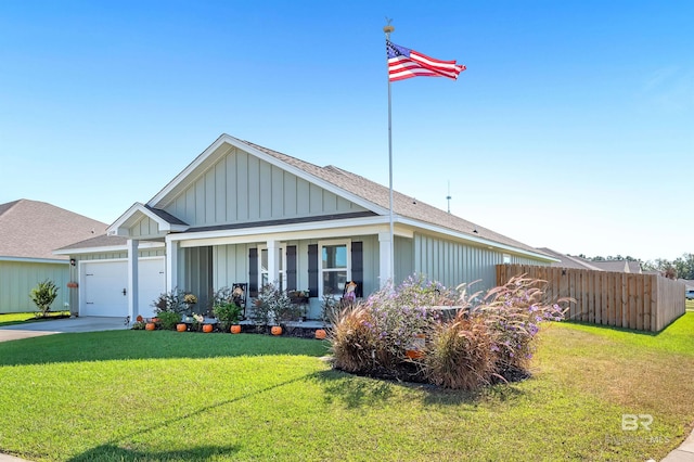 ranch-style home featuring covered porch, a front yard, and a garage