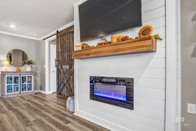 22310 Early Dawn Cir, Foley, AL 36535 - living area featuring crown molding, a glass covered fireplace, wood finished floors, baseboards, and a barn door