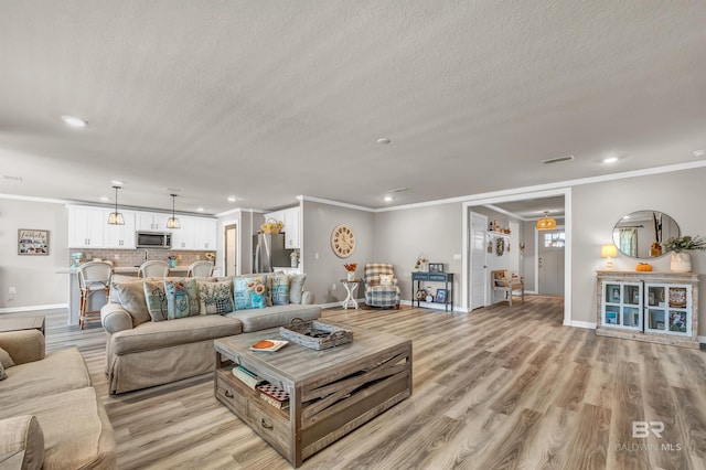 22310 Early Dawn Cir, Foley, AL 36535 - living room featuring crown molding, recessed lighting, and baseboards